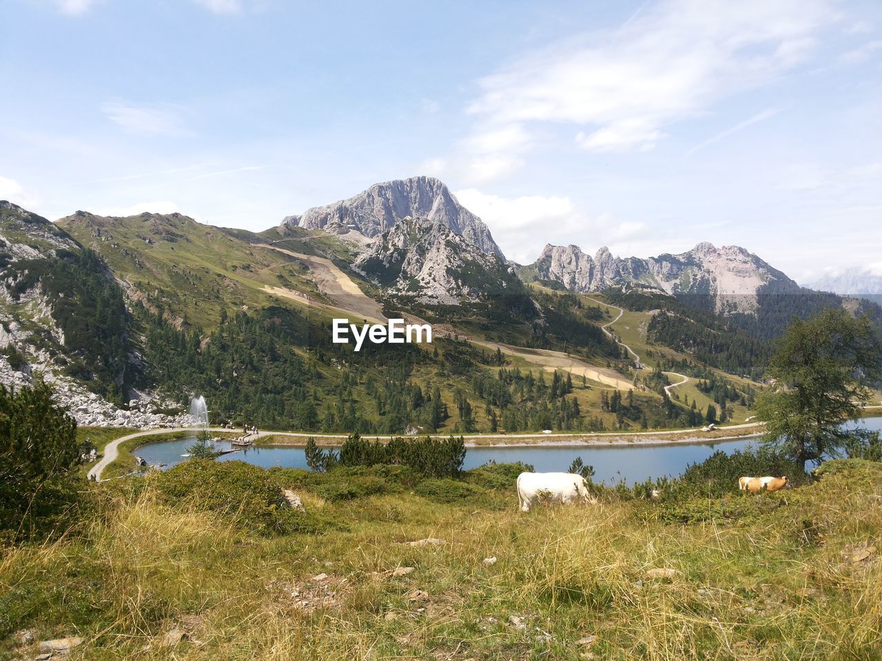 Scenic view of lake and mountains against sky