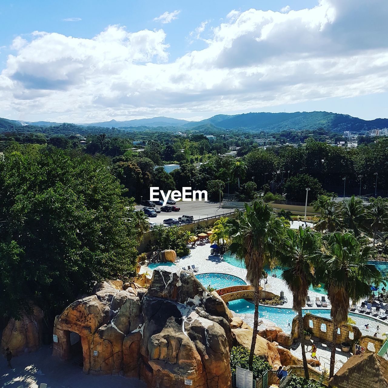 TREES BY SWIMMING POOL AGAINST SKY