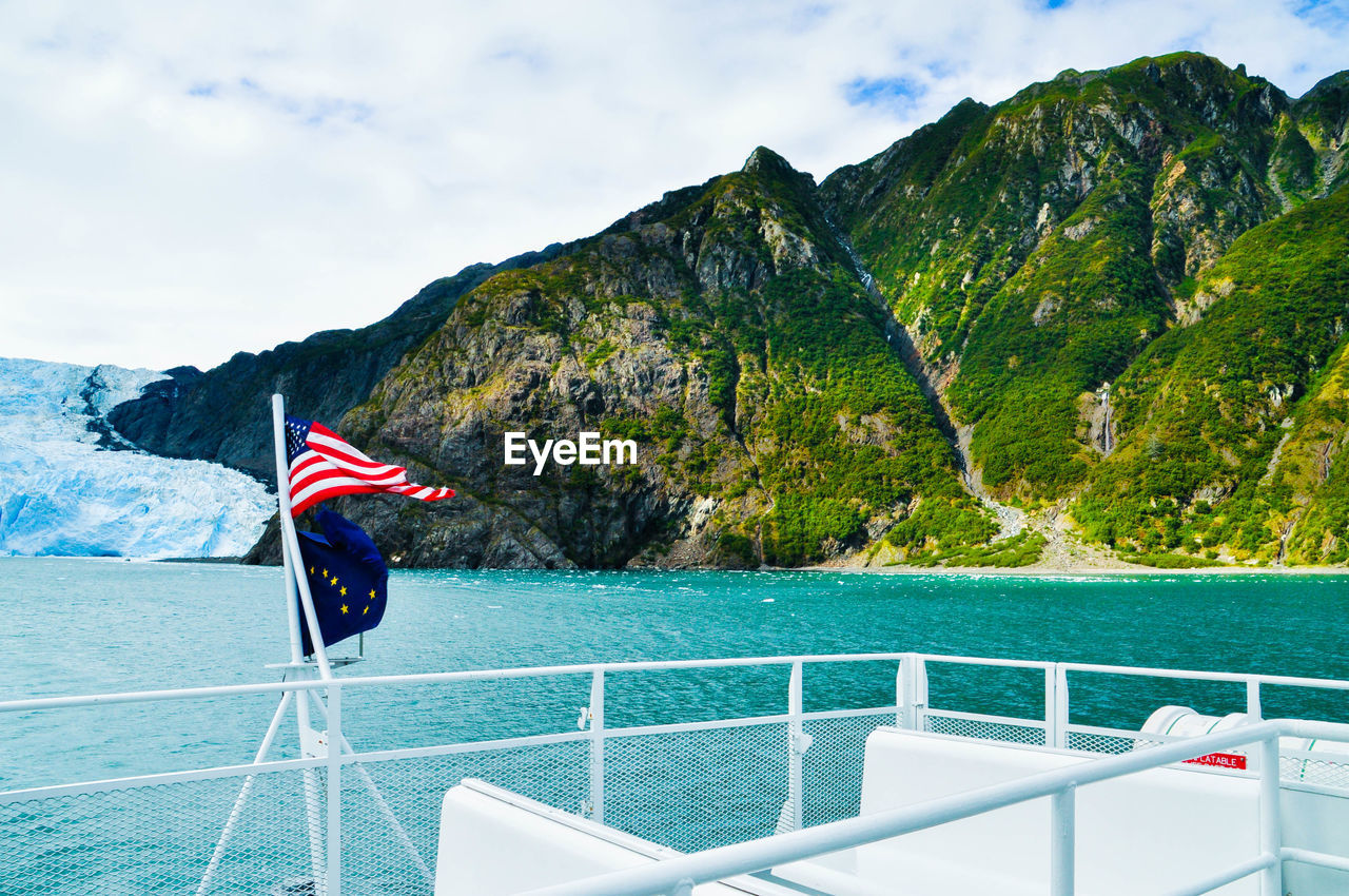 Scenic view of flag on boat against sky