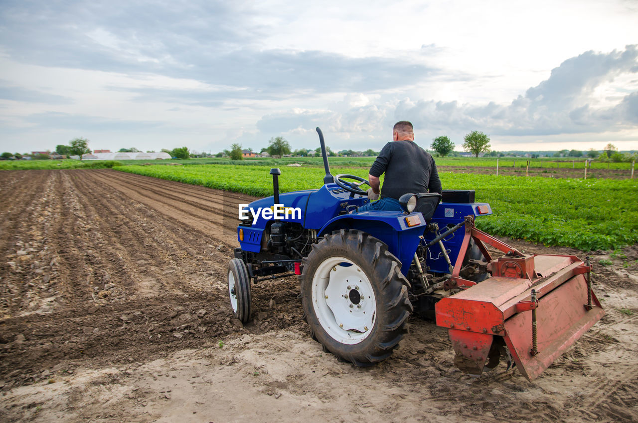 Kherson oblast, ukraine - may 29, 2021. a farmer on a tractor clears the field. milling soil,