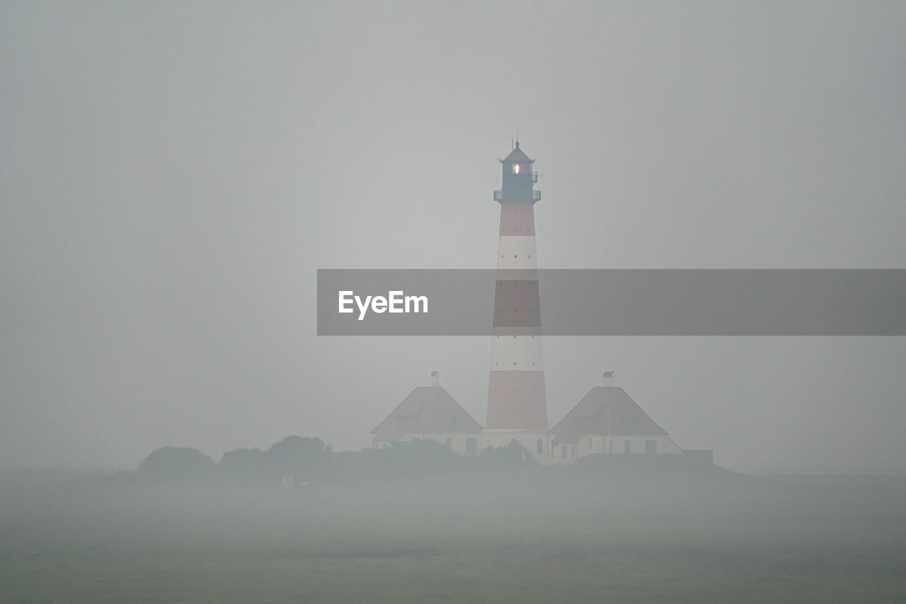 lighthouse, architecture, built structure, guidance, fog, building exterior, tower, building, sky, nature, water, security, no people, protection, sea, travel destinations, environment, travel, outdoors, land, beach, day, scenics - nature, landscape, copy space, tranquility, beauty in nature, coastline, history