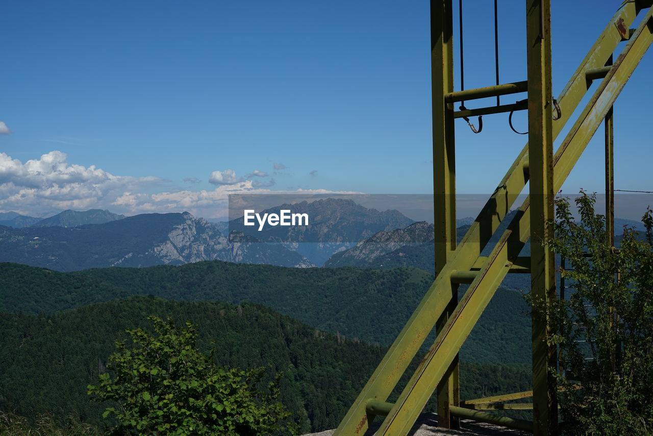 Scenic view of mountains against blue sky