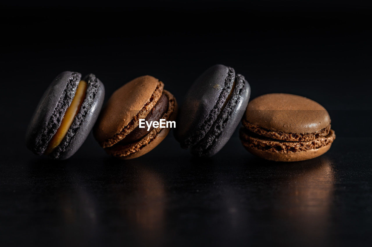 food, baseball, studio shot, indoors, still life, baseball - ball, food and drink, black background, no people, close-up, group of objects, sports, brown, table, in a row