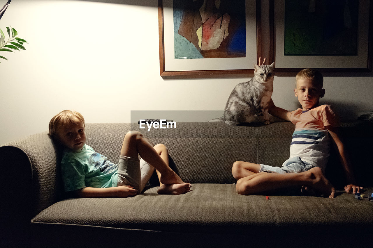 BOYS SITTING ON SOFA