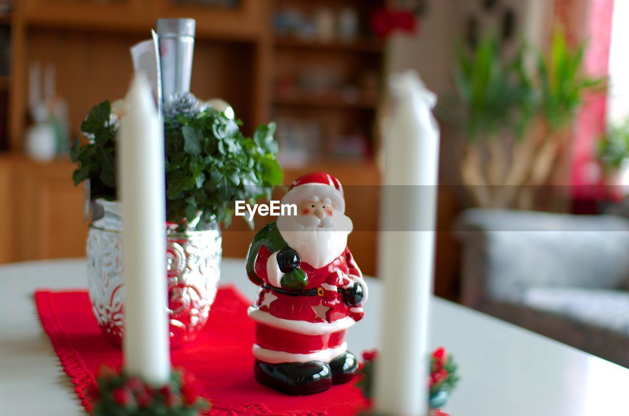 Close-up of santa claus figurine on table