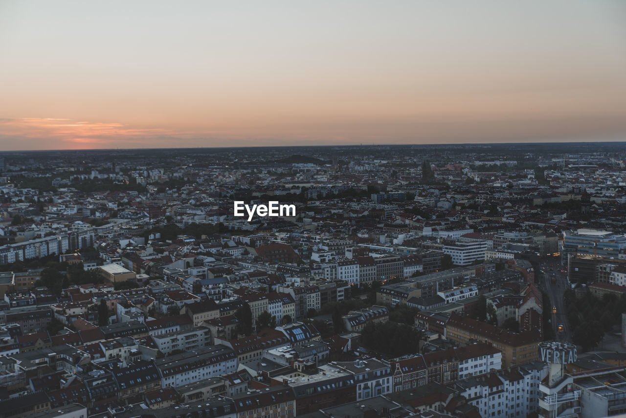 HIGH ANGLE VIEW OF BUILDINGS AT SUNSET
