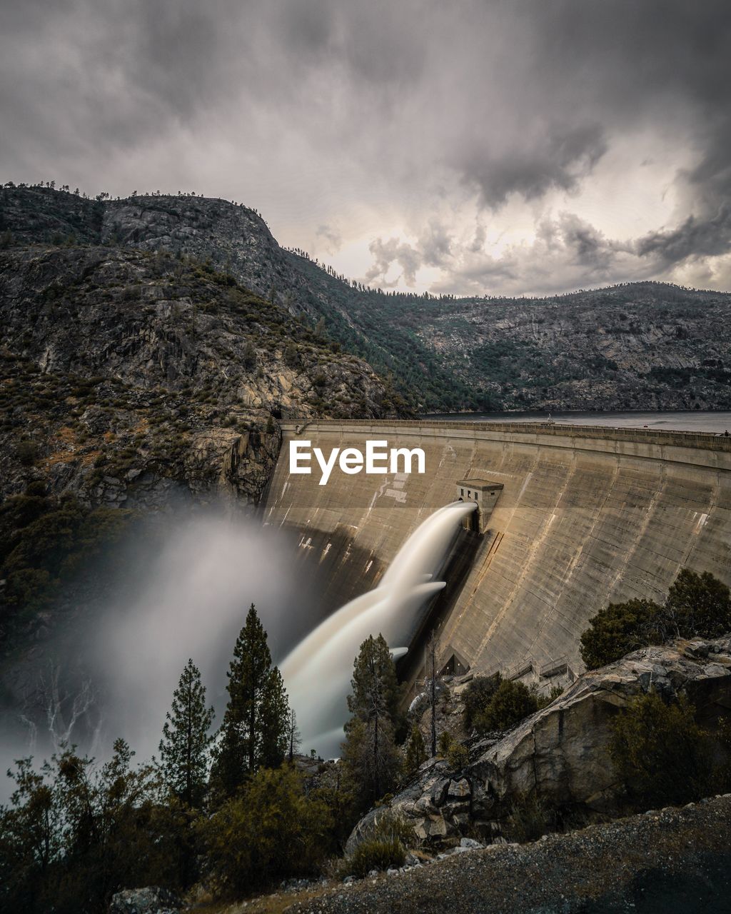 Blurred motion of water from dam against sky