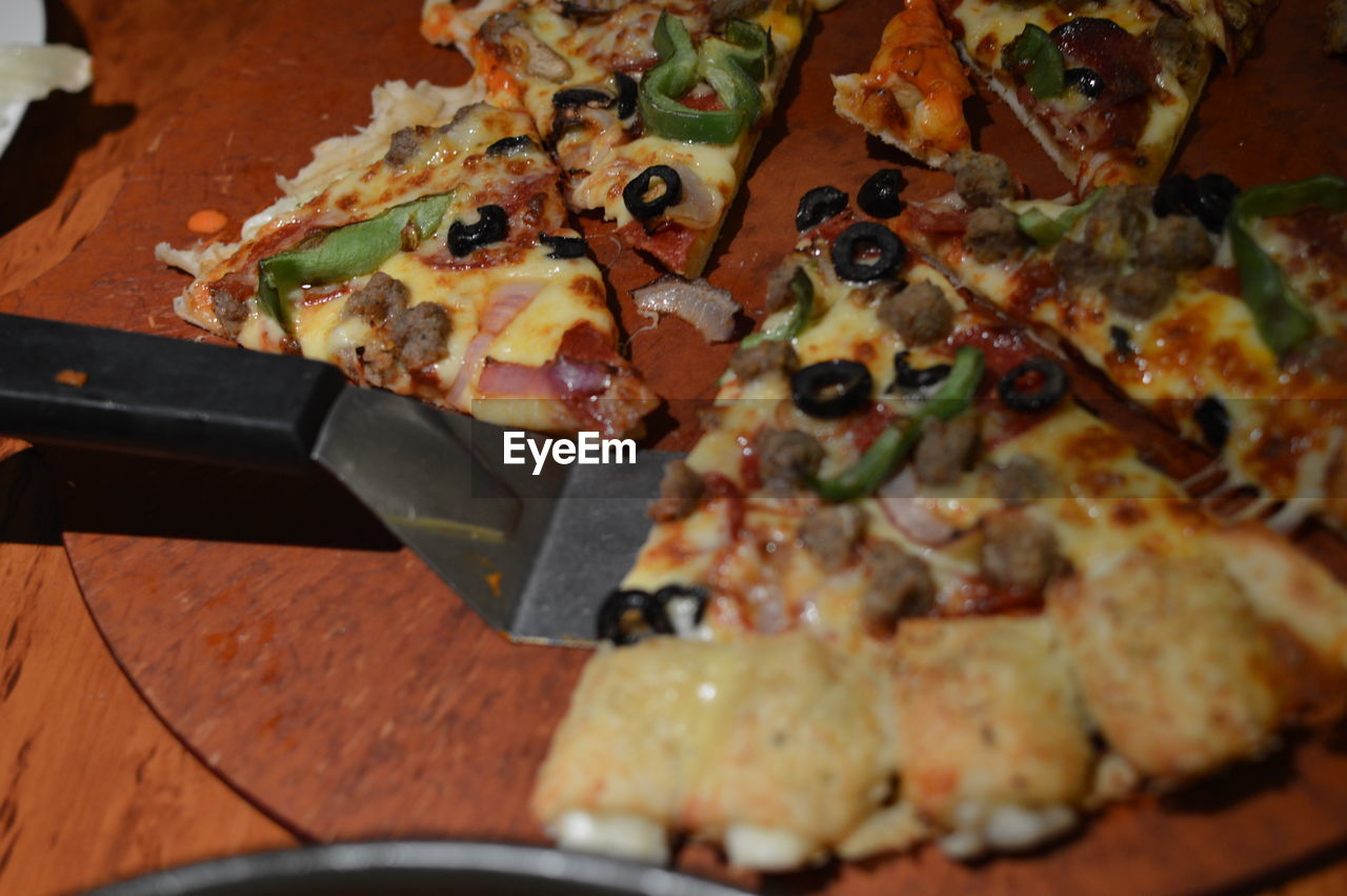 High angle view of fresh pizza with spatula