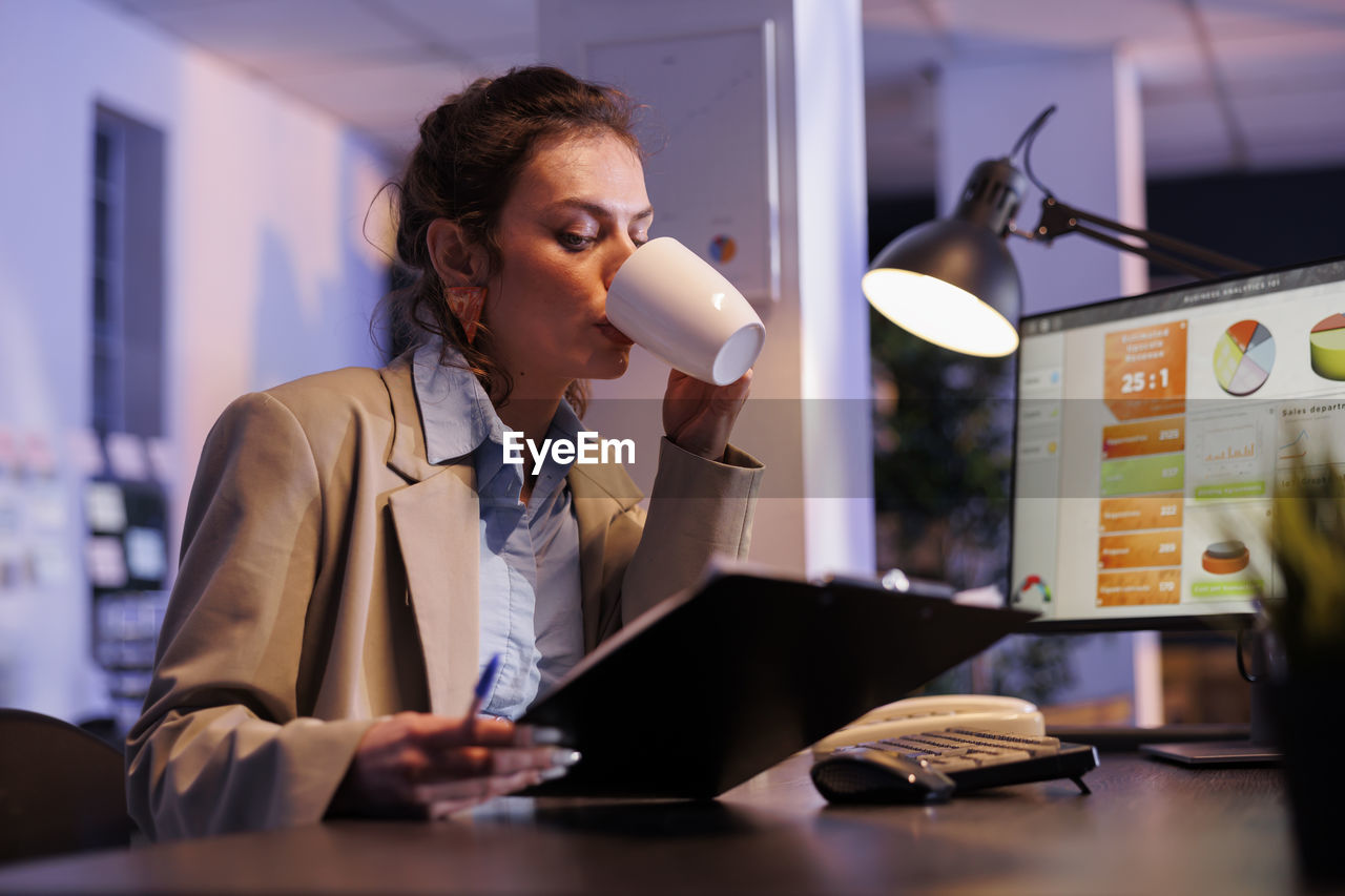 businesswoman working at table in office