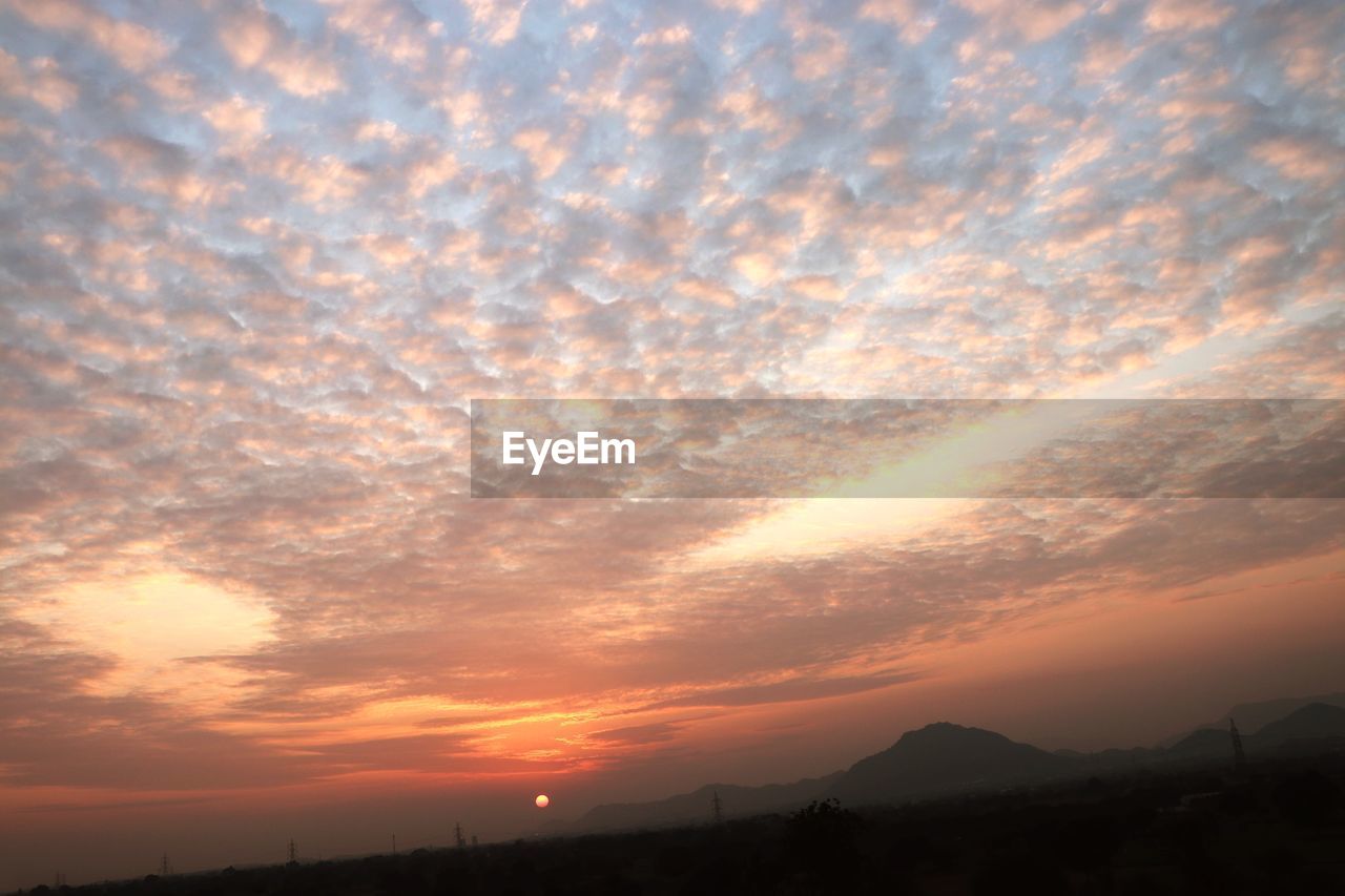 SCENIC VIEW OF SILHOUETTE MOUNTAIN AGAINST DRAMATIC SKY