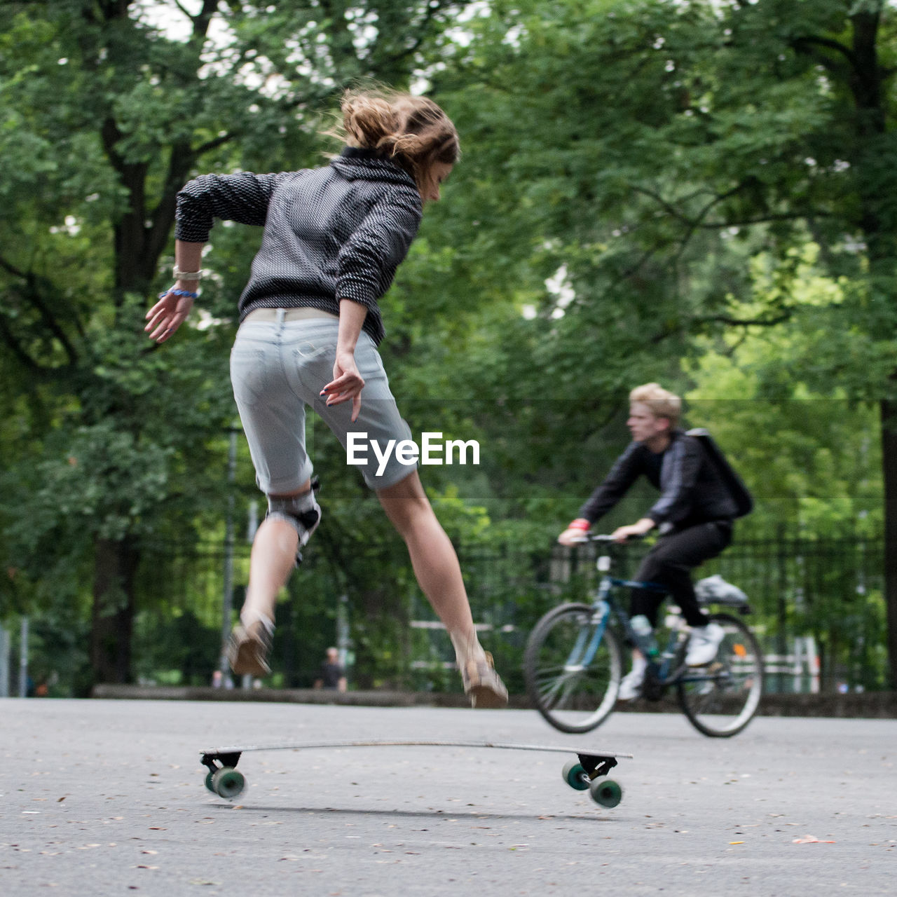 WOMAN JUMPING ON ROCK