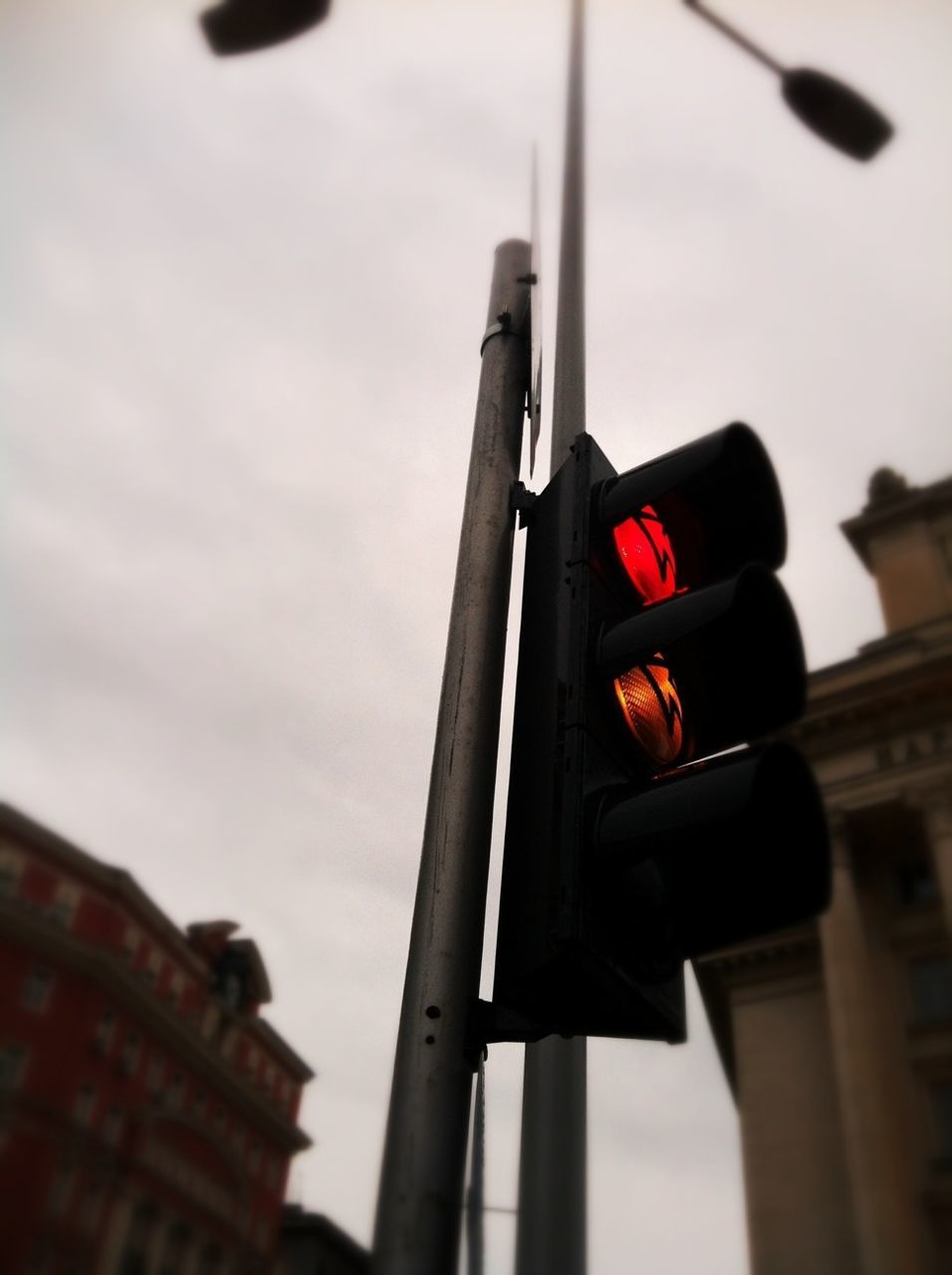 Low angle view of traffic light against sky