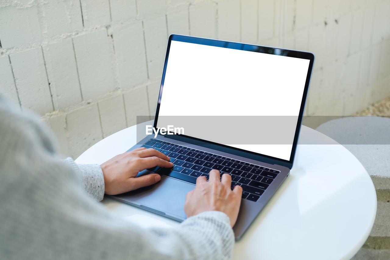 midsection of woman using laptop