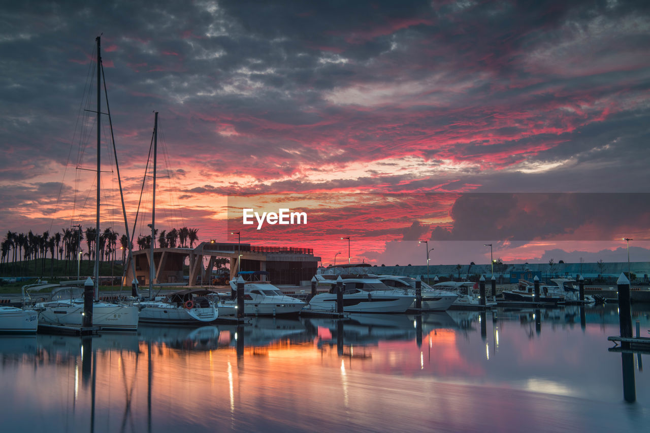 Sailboats in marina at sunset