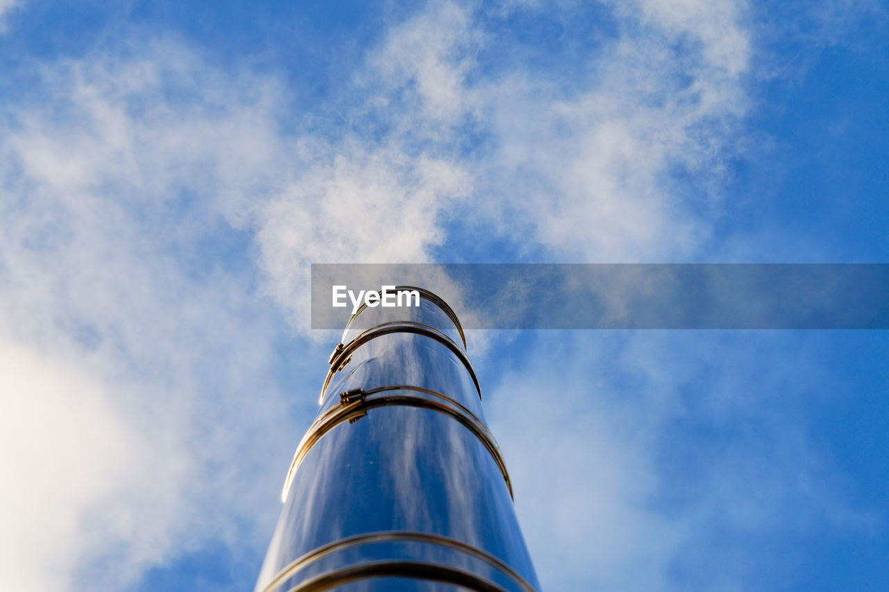 Low angle view of smoke stack against sky