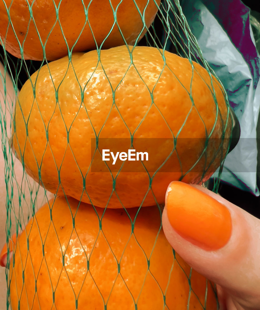 orange, yellow, produce, orange color, food, pumpkin, fruit, hand, chainlink fence, close-up, food and drink, fence, one person, clementine, healthy eating, plant, sports, outdoors, day, netting, holding, ball, wellbeing