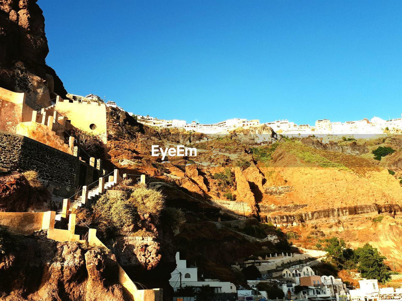 LOW ANGLE VIEW OF TOWN AGAINST BLUE SKY