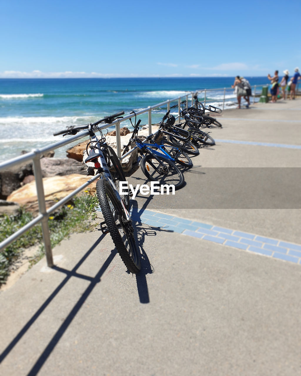 BICYCLE ON BEACH AGAINST SKY