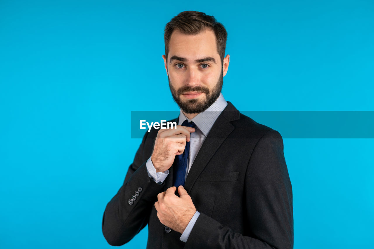 PORTRAIT OF MAN AGAINST BLUE SKY