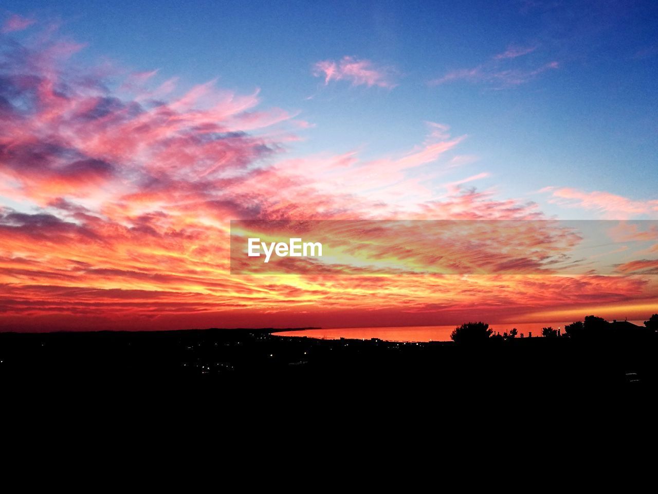 Scenic view of silhouette landscape against sky during sunset