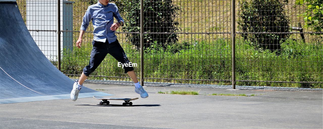 Low section of boy skateboarding