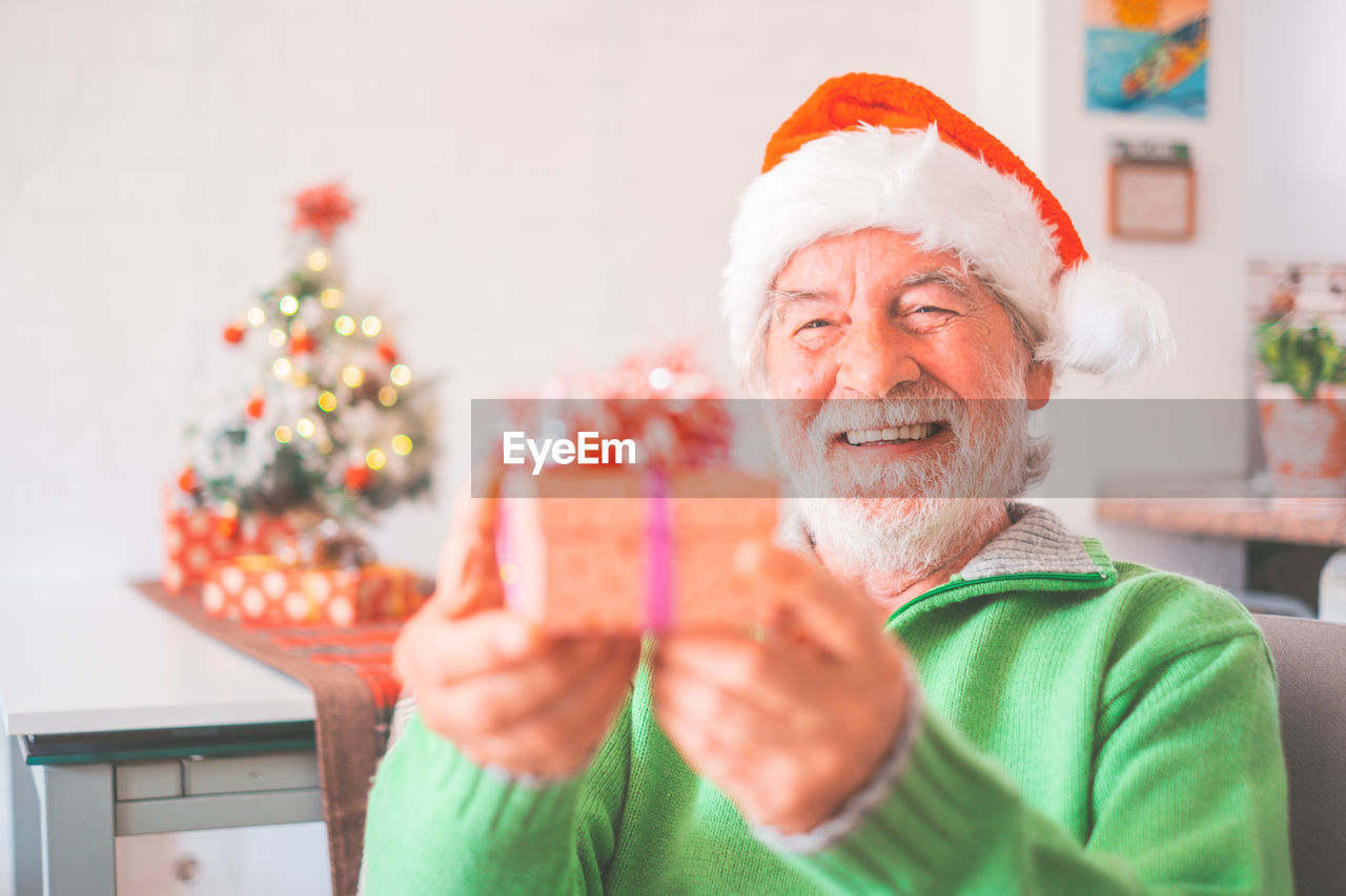 portrait of young woman holding christmas presents