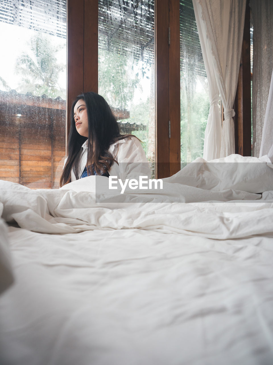 Young woman relaxing on bed at home