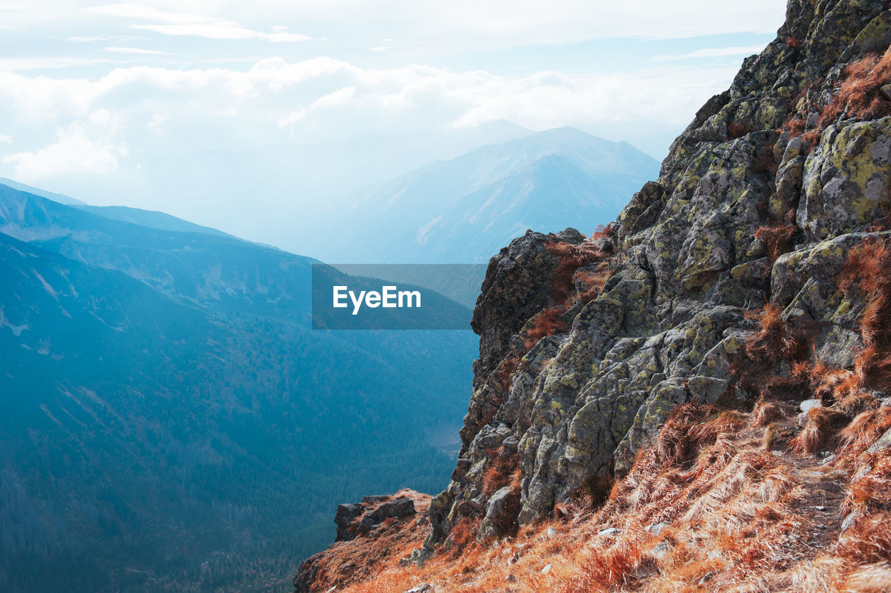 Scenic view of rocky mountains against sky on sunny day