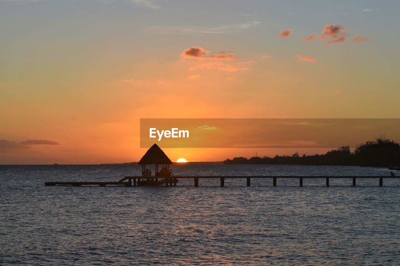 Scenic view of sea against orange sky