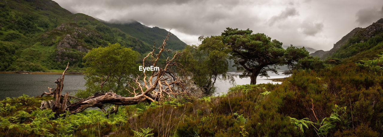 panoramic view of river amidst mountains against sky