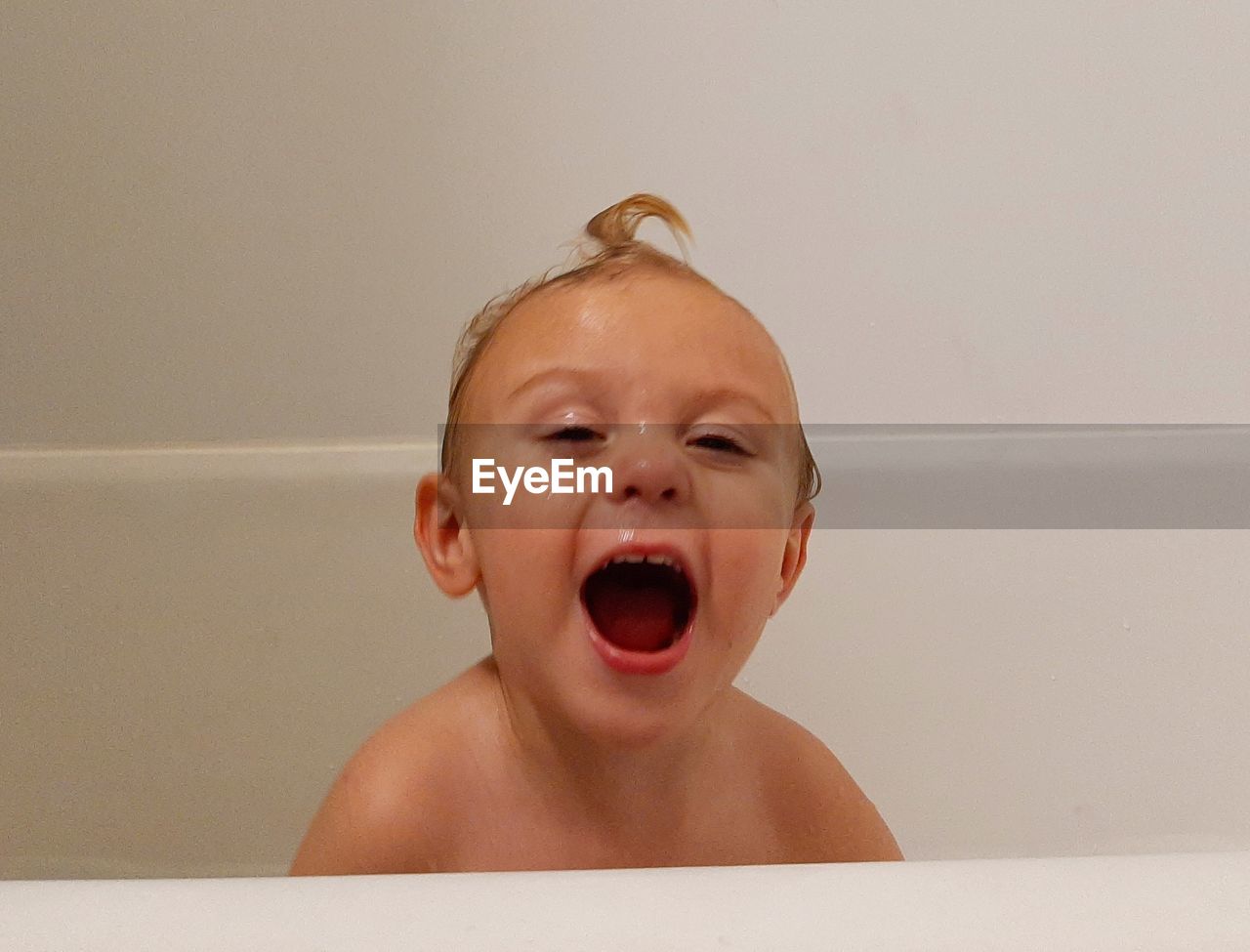 PORTRAIT OF CUTE BOY IN BATHROOM