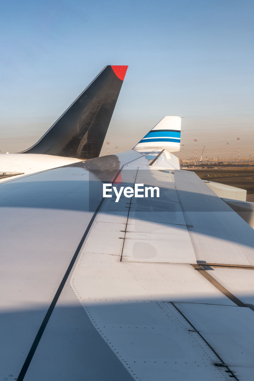 AIRPLANE WING AGAINST CLEAR BLUE SKY