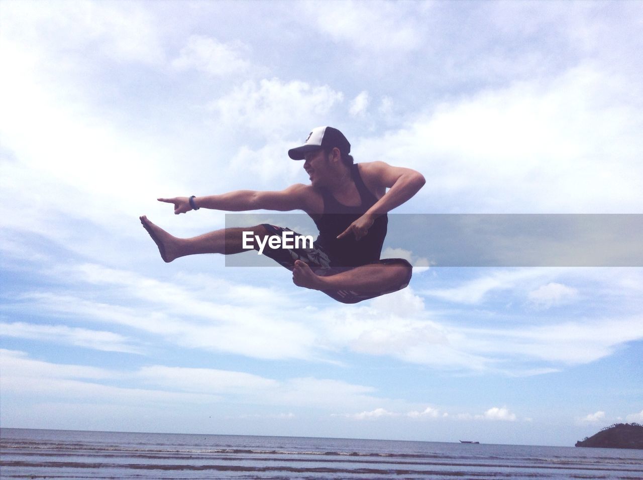 Full length of a young man jumping on beach