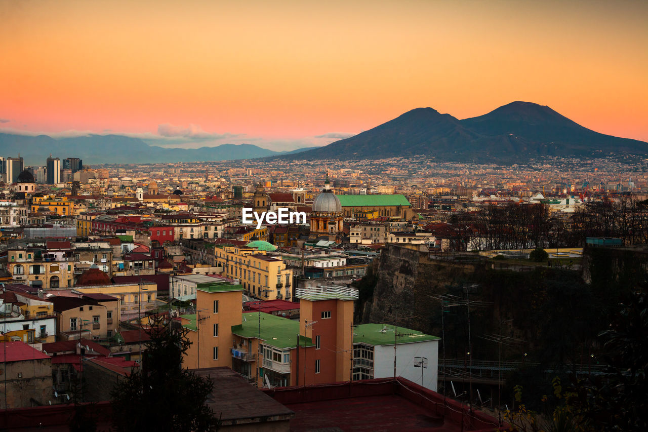 High angle shot of townscape against sky at sunset