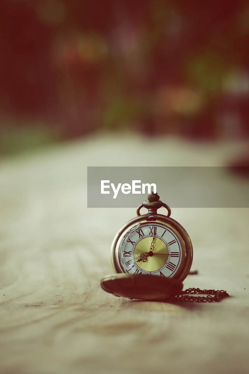 Close-up of antique pocket watch on table