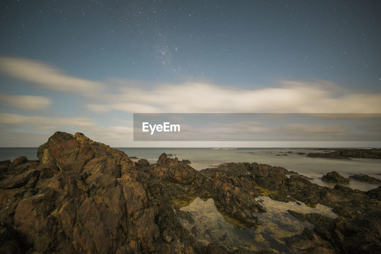 Scenic view of sea against sky at night