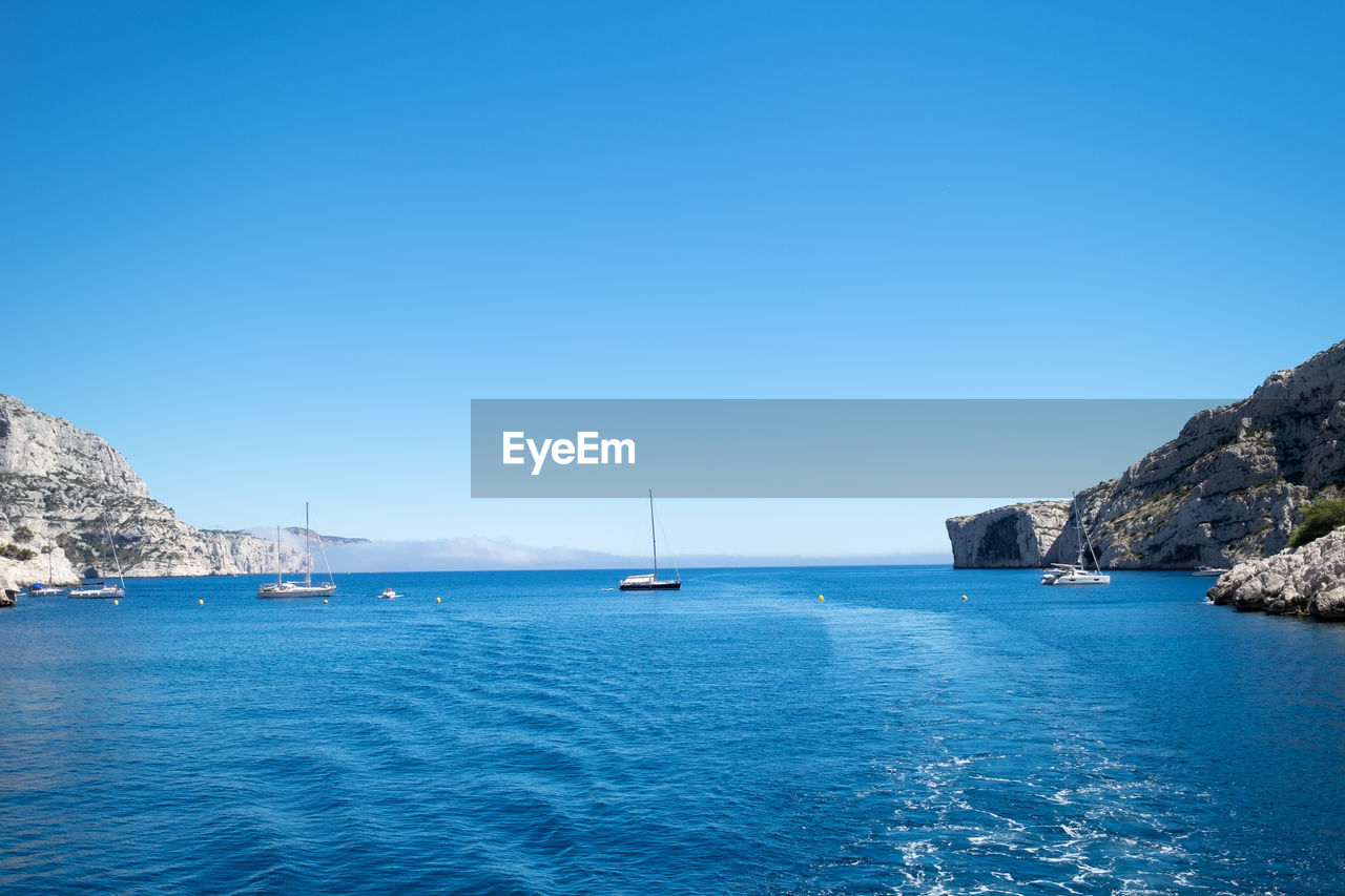 Scenic view of sea against clear blue sky