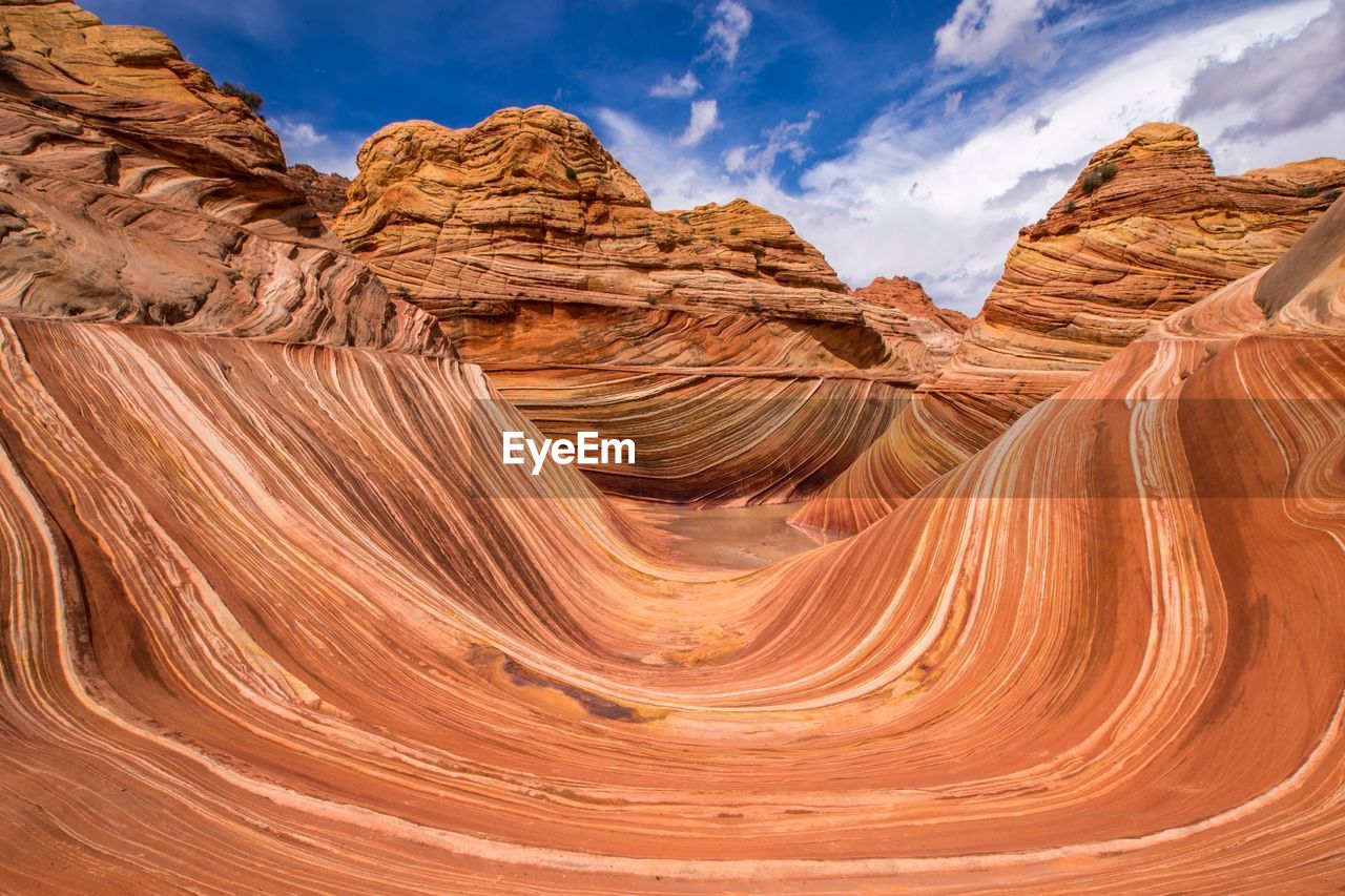 Scenic view of rocky mountains against sky on sunny day at coyote buttes