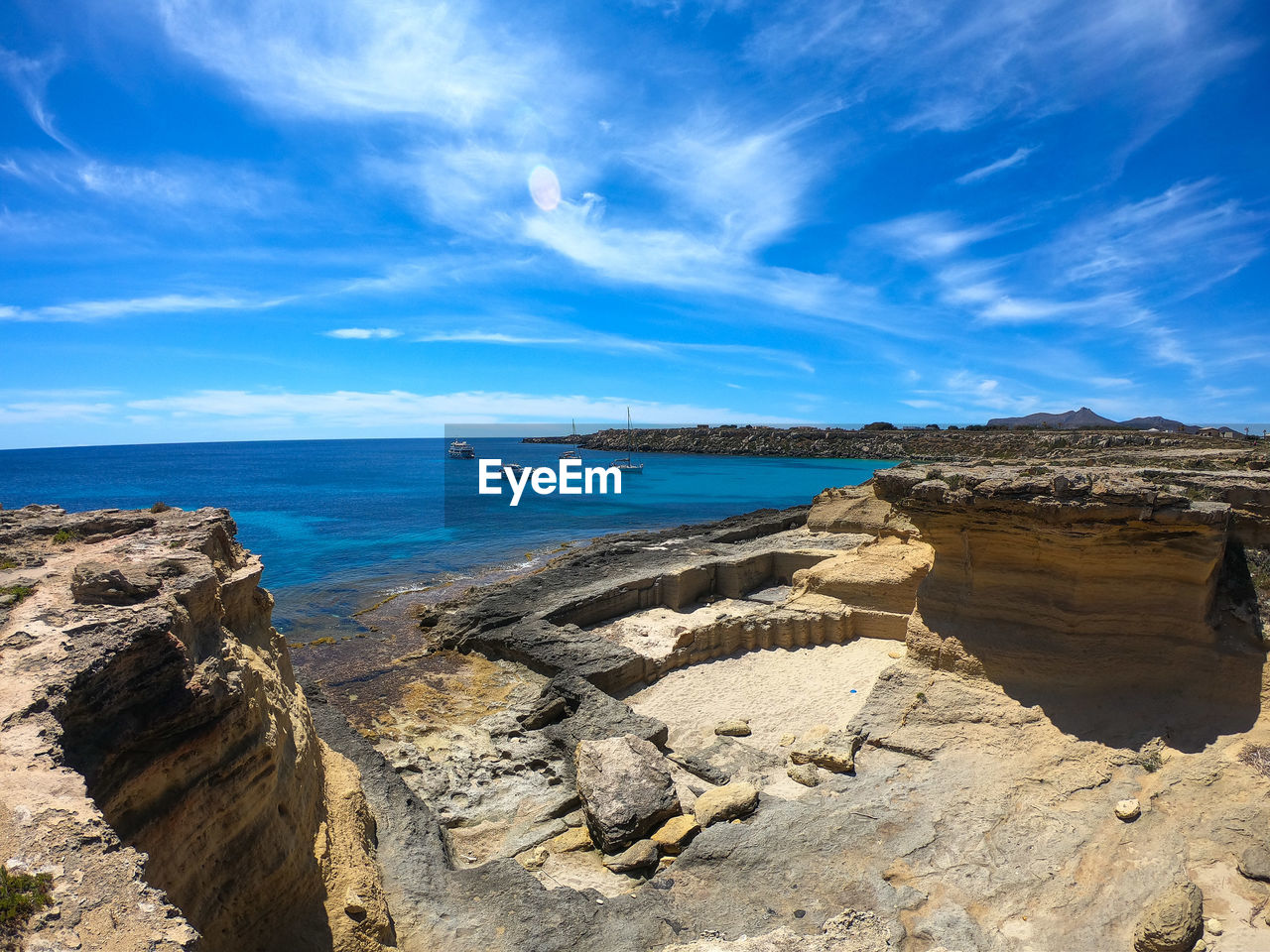 SCENIC VIEW OF BEACH AGAINST BLUE SKY