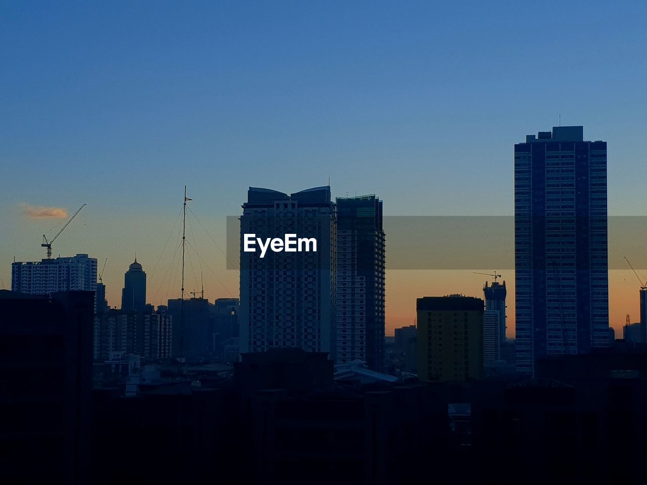 SKYSCRAPERS AGAINST SKY DURING SUNSET