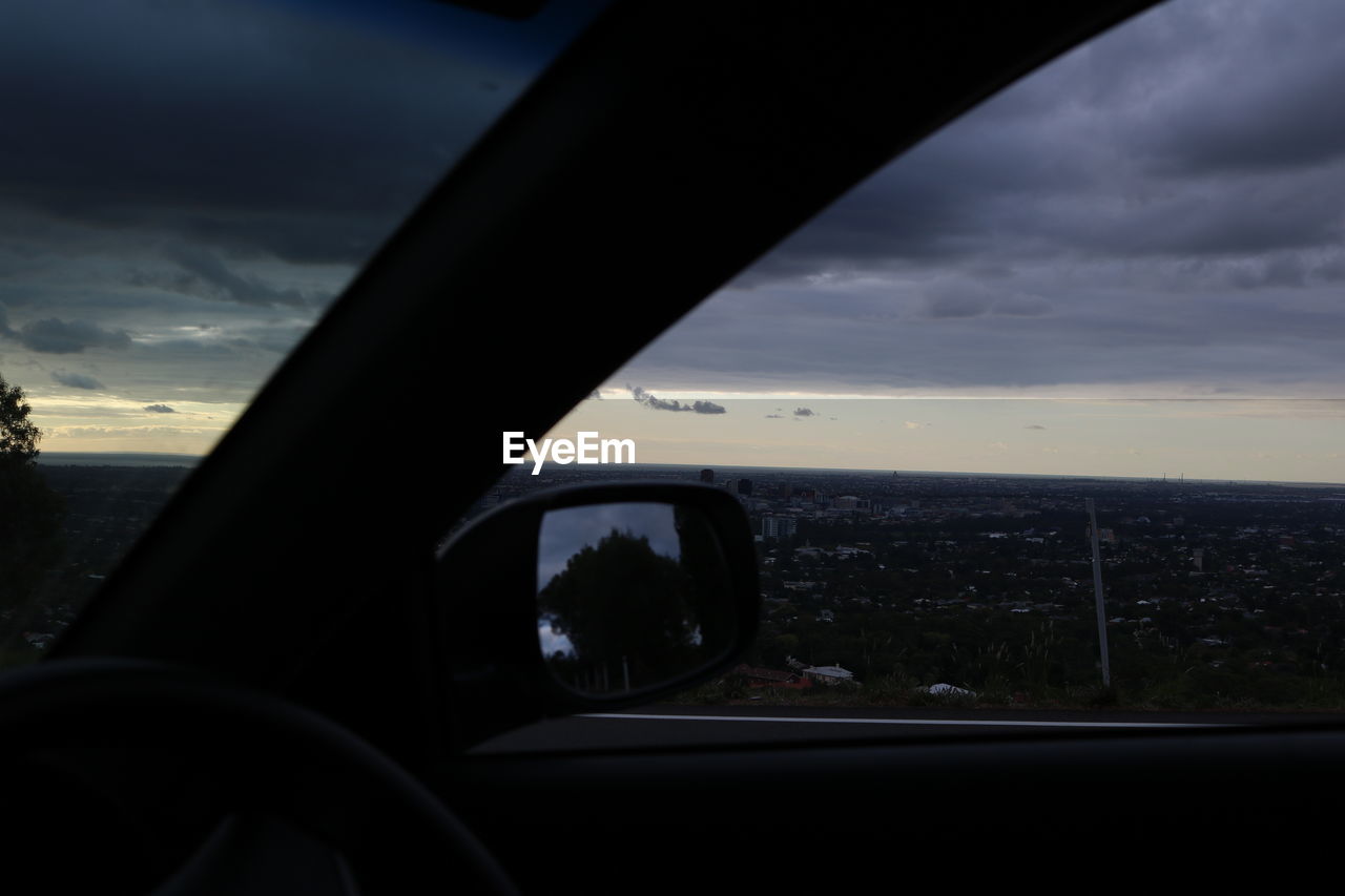 VIEW OF ROAD AGAINST CLOUDY SKY