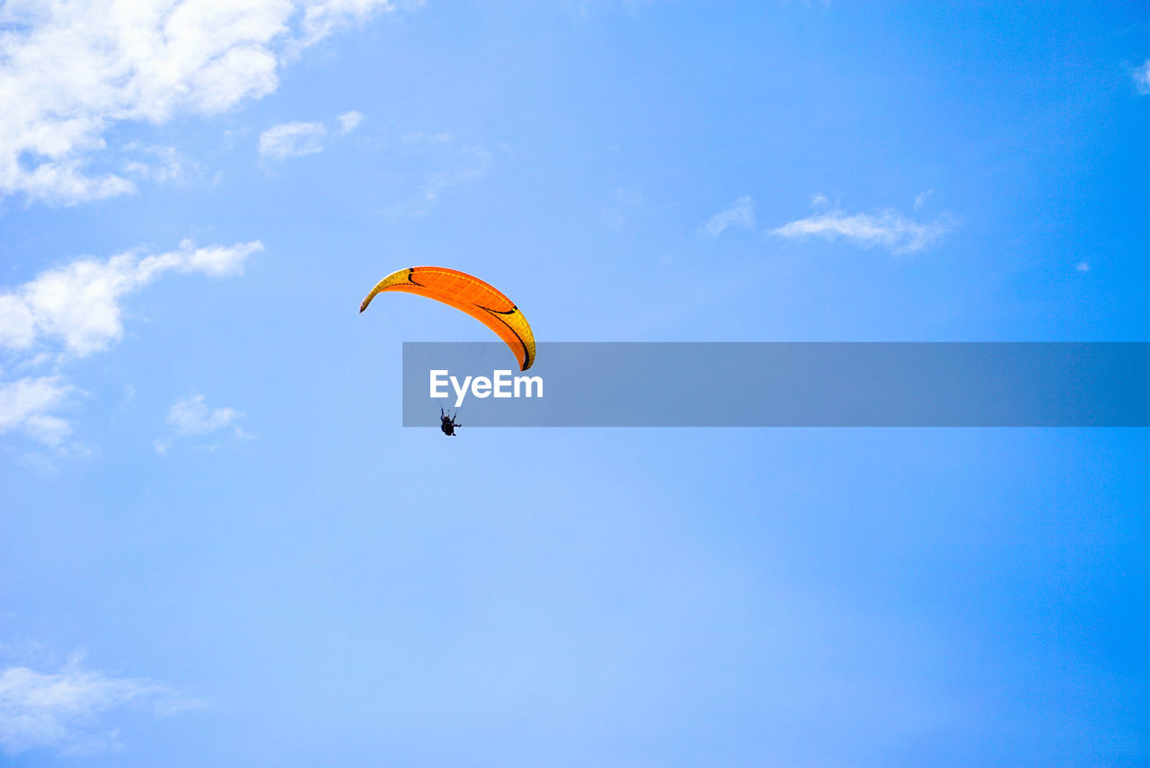 low angle view of person paragliding against clear sky