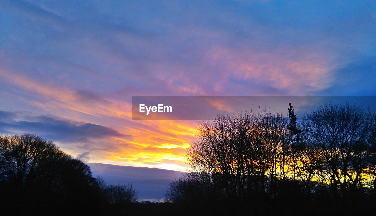 SCENIC VIEW OF DRAMATIC SKY DURING SUNSET