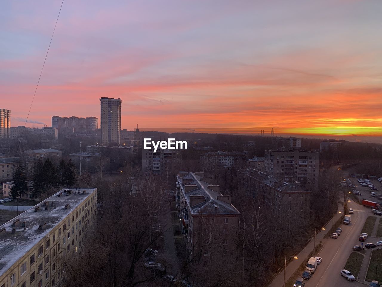 High angle view of buildings in city during sunset