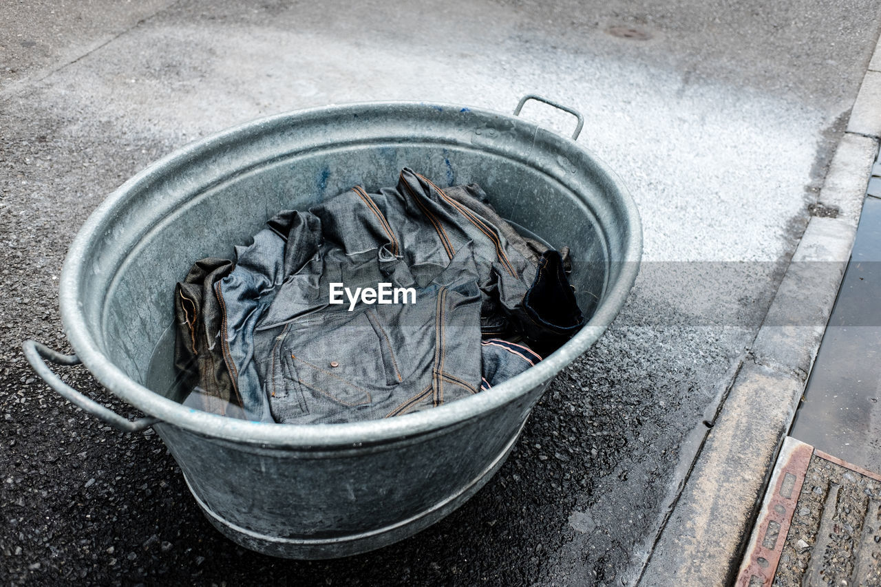 High angle view of jeans in container