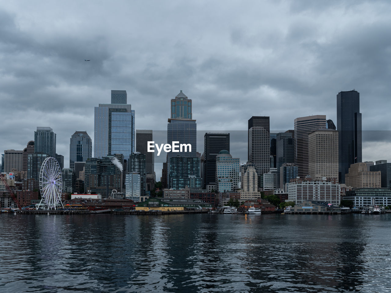 city, architecture, skyline, building exterior, built structure, building, landscape, office building exterior, skyscraper, cityscape, urban skyline, sky, water, urban area, horizon, downtown district, cloud, residential district, downtown, metropolis, waterfront, tower block, nature, travel destinations, metropolitan area, office, city life, reflection, no people, travel, overcast, business, nautical vessel, outdoors, transportation, landmark, dusk, sea, ship, harbor, dramatic sky, environment, development, business finance and industry