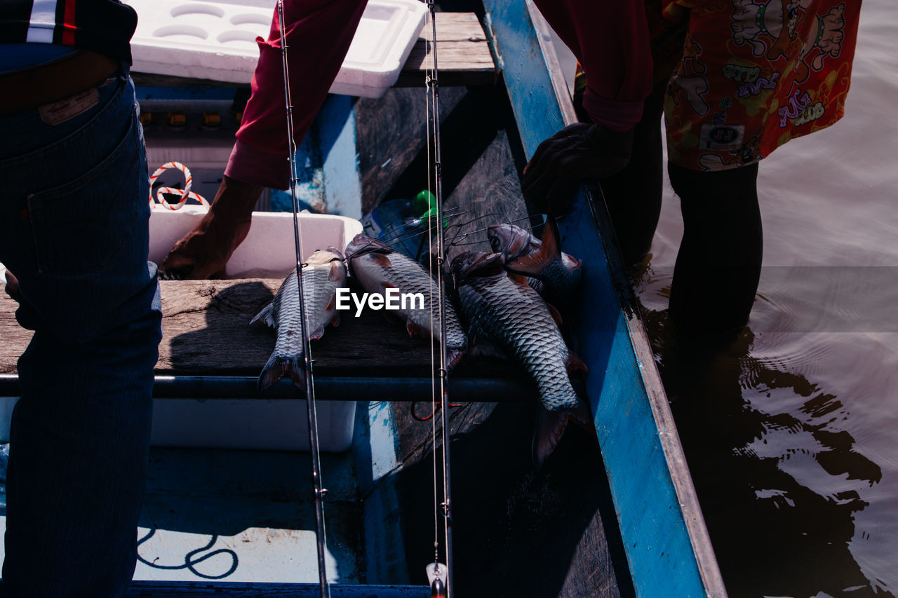 Low section of people working in boat