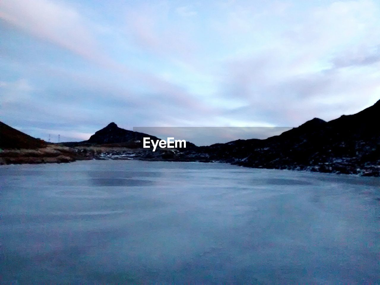 SCENIC VIEW OF LAKE AND MOUNTAINS