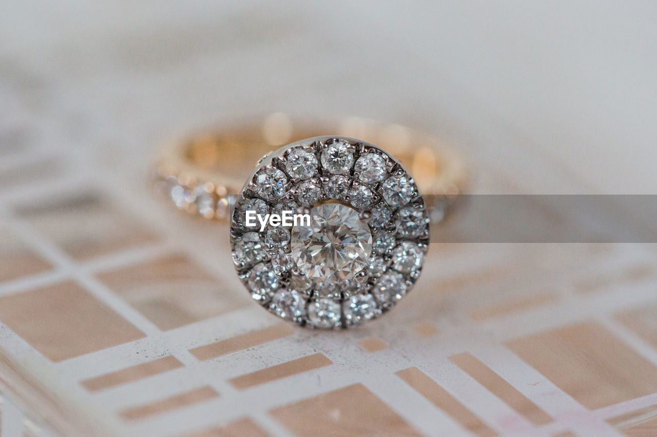 Close-up of diamond ring on table