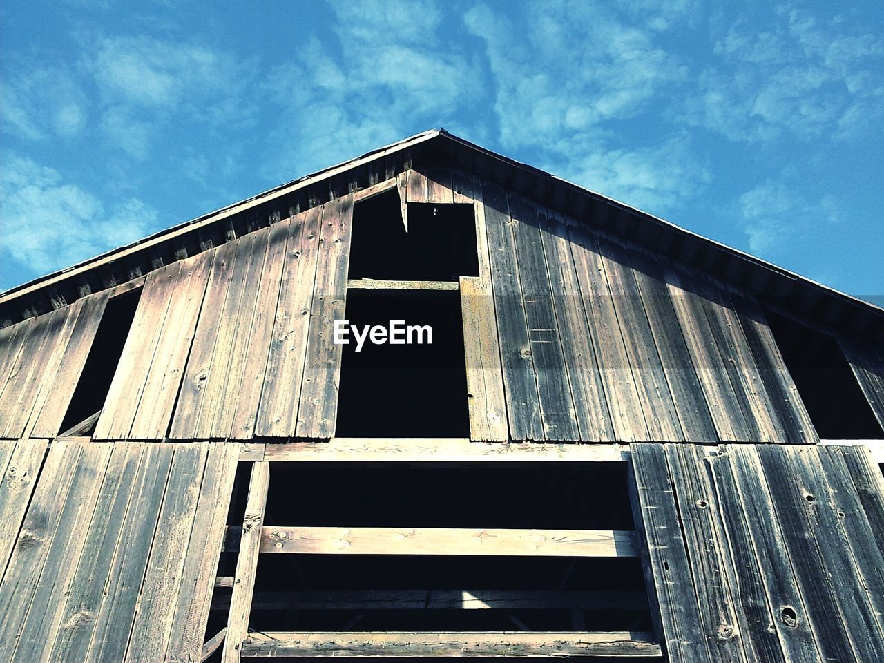 Low angle view of old wooden building against sky